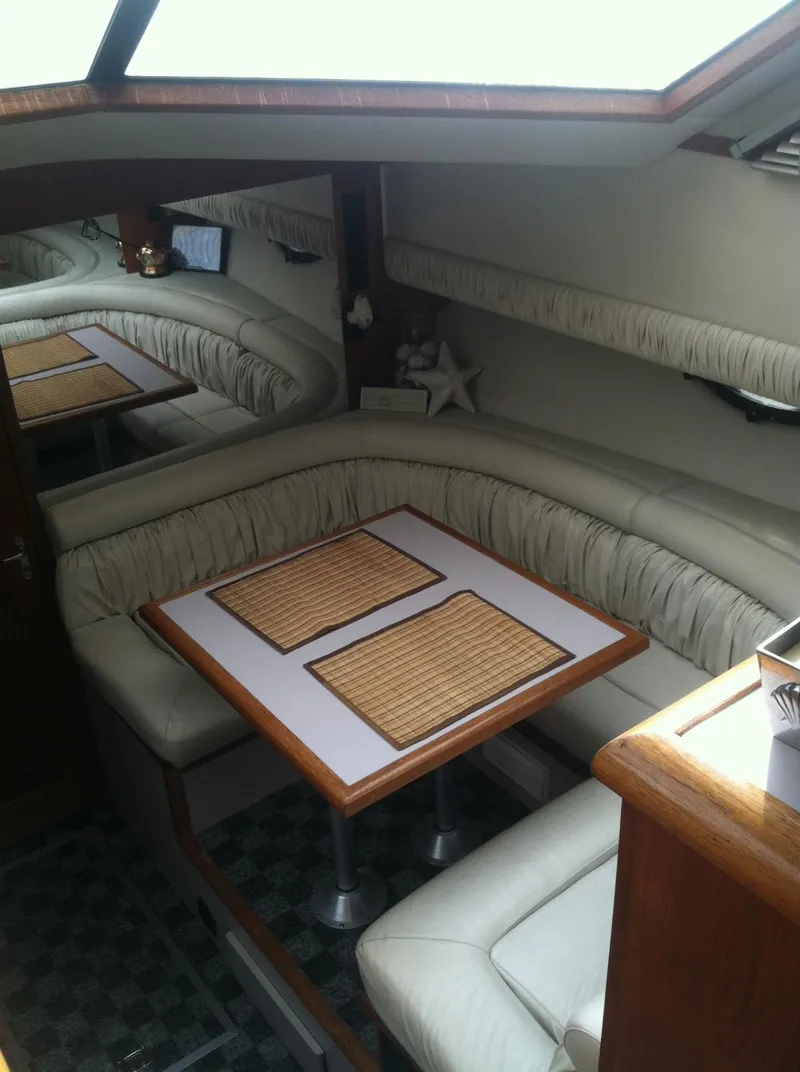 Slide: The Image of Interior of 1989 Californian 48 Motor Yacht with cozy dining area and plush seating. - 29