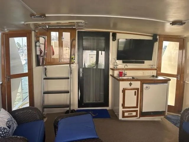 Slide: The Image of Interior of 1989 Californian 48 Motor Yacht with kitchenette and seating area. - 33