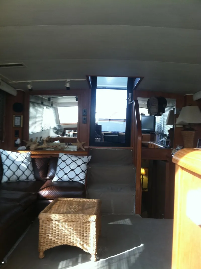 Slide: The Image of Interior of 1989 Californian 48 Motor Yacht with cozy seating and wicker table. - 34