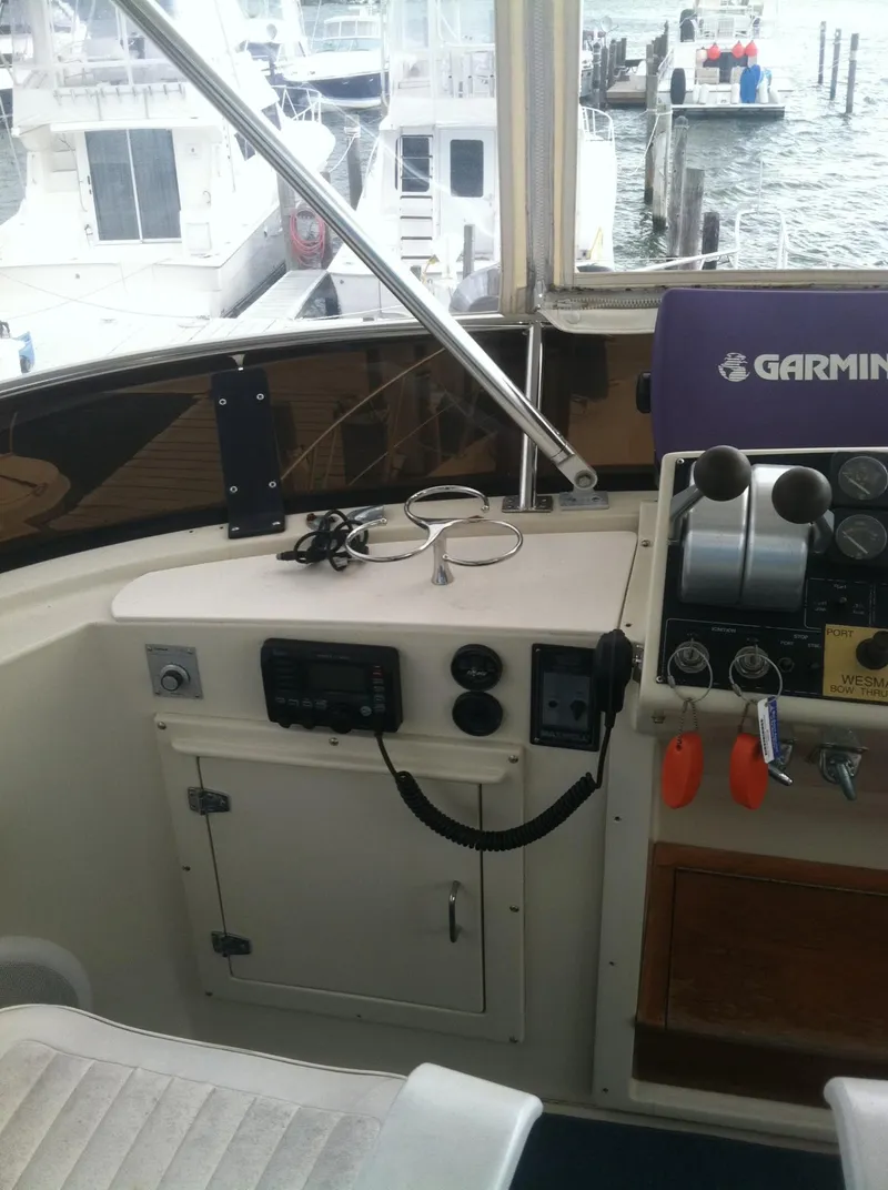 Slide: The Image of 1989 Californian 48 Motor Yacht helm with Garmin navigation system, docked at marina. - 36