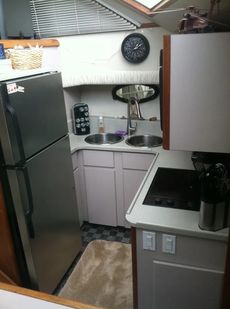 Slide: The Image of Compact kitchen in 1989 Californian 48 Motor Yacht with modern appliances and dual sinks. - 38