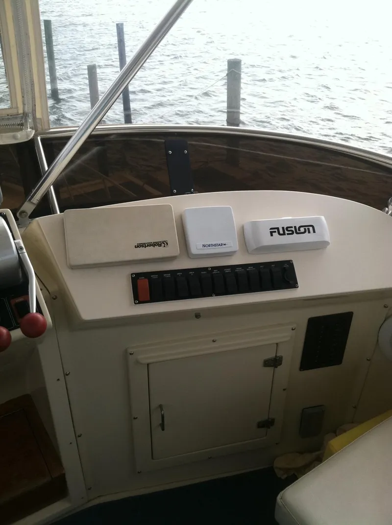 Slide: The Image of 1989 Californian 48 Motor Yacht dashboard with marine electronics and controls. - 39