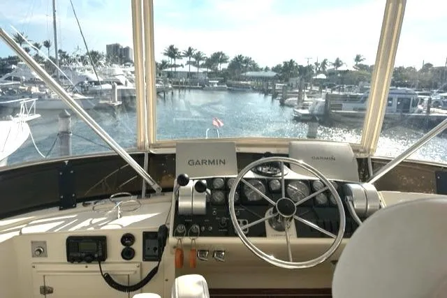 Slide: The Image of 1989 Californian 48 Motor Yacht helm with Garmin navigation, overlooking marina. - 45