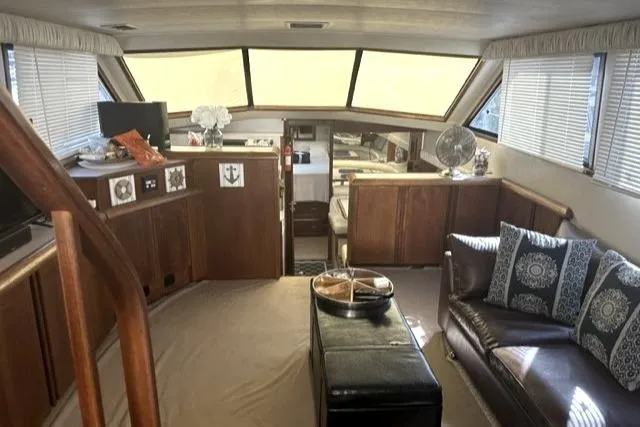 Slide: The Image of Interior of 1989 Californian 48 Motor Yacht with elegant wood finish and cozy seating. - 49