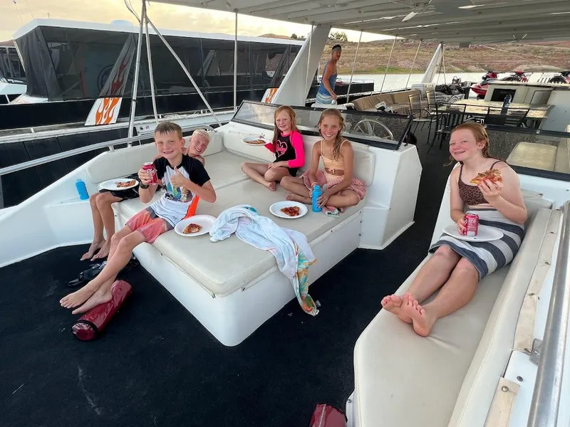 Slide: The Image of Children enjoying pizza on a 2005 Stardust Cruisers Multi Owner Houseboat. - 11