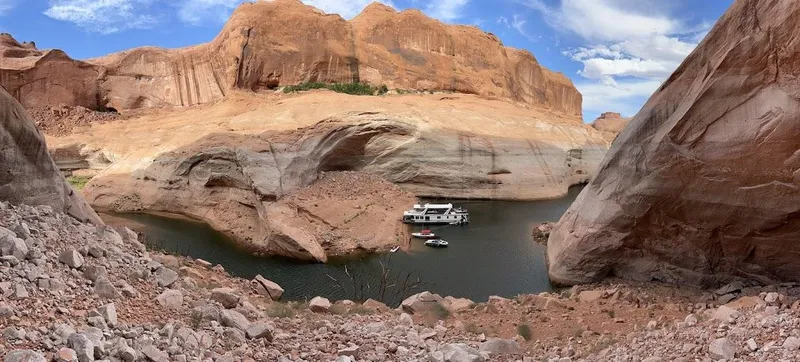 Slide: The Image of Houseboat on serene lake surrounded by rocky canyon, clear sky above. Stardust Cruisers 2005 model. - 12