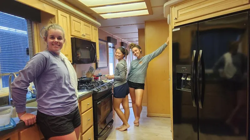Slide: The Image of Three women in the kitchen of a 2005 Stardust Cruisers Multi Owner Houseboat. - 13