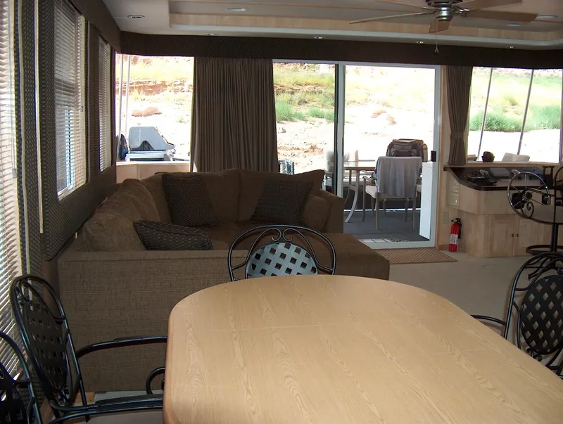 Slide: The Image of Interior of 2005 Stardust Cruisers Multi Owner Houseboat with dining area and lounge. - 4