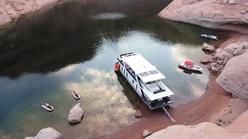 Slide: The Image of 2005 Stardust Cruisers Multi Owner Houseboat docked in a serene canyon lake. - 5