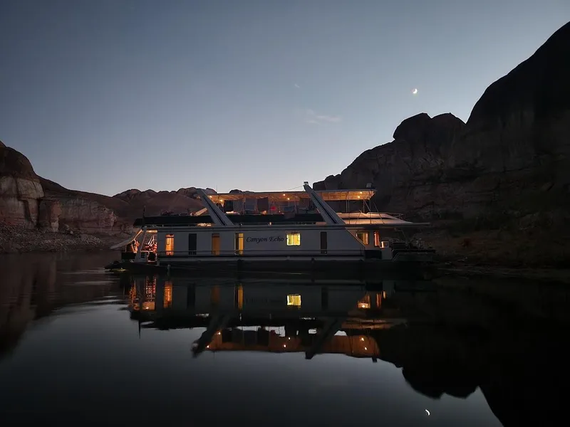 Slide: The Image of 2005 Stardust Cruisers Multi Owner Houseboat on a serene lake at dusk. - 7
