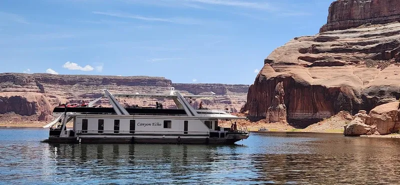 Slide: The Image of 2005 Stardust Cruisers Multi Owner Houseboat on a scenic lake with rocky cliffs. - 8