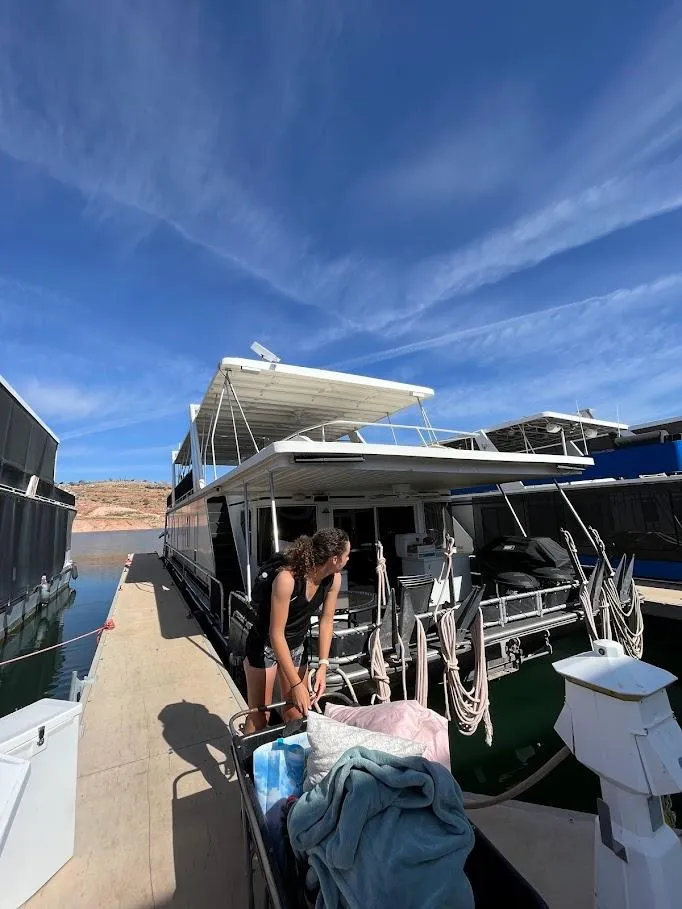 Slide: The Image of 2005 Stardust Cruisers Multi Owner Houseboat docked with person on deck under clear sky. - 9