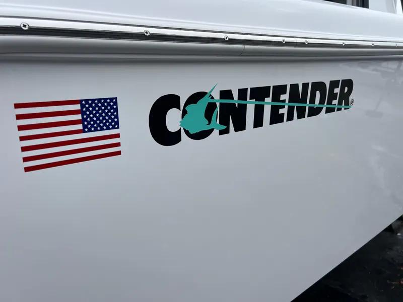Slide: The Image of 2025 Contender 28S boat with logo and American flag decal. - 16