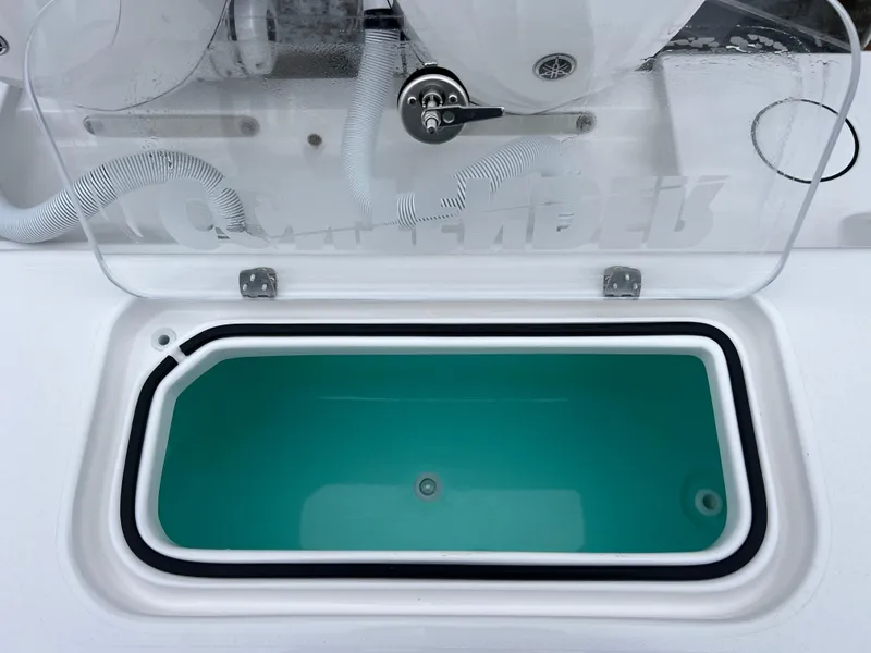 Slide: The Image of 2025 Contender 28S livewell with open lid, showcasing interior design. - 17