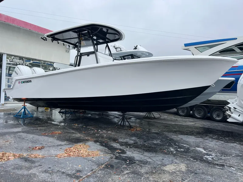 Slide: The Image of 2025 Contender 28S boat on stands, white hull, black bottom, outdoor display. - 4
