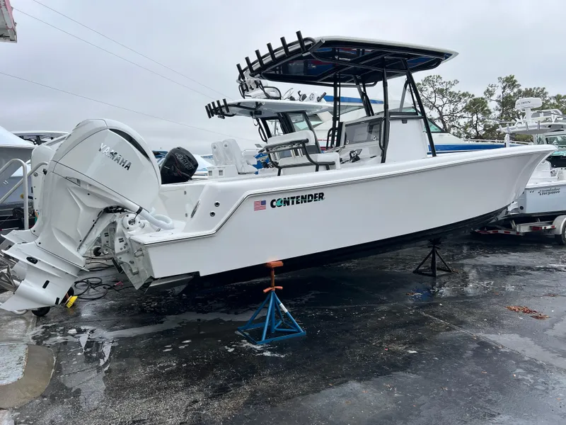 Slide: The Image of 2025 Contender 28S boat with Yamaha engine on display in a marina. - 5