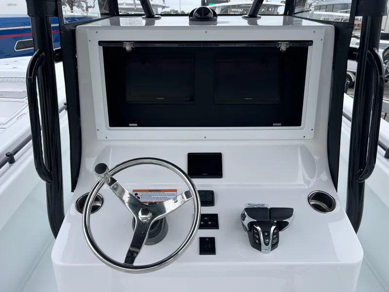 Slide: The Image of Helm of 2025 Contender 28S boat with steering wheel and control panel. - 9