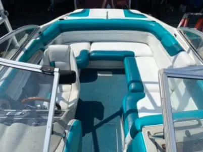 Slide: The Image of 1996 Maxum 2100SS Ski boat interior with teal and white seating. - 11