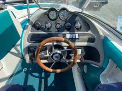 Slide: The Image of 1996 Maxum 2100SS Ski boat dashboard with wooden steering wheel and instrument panel. - 6