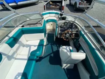 Slide: The Image of 1996 Maxum 2100SS Ski boat interior with teal and white seating. - 7