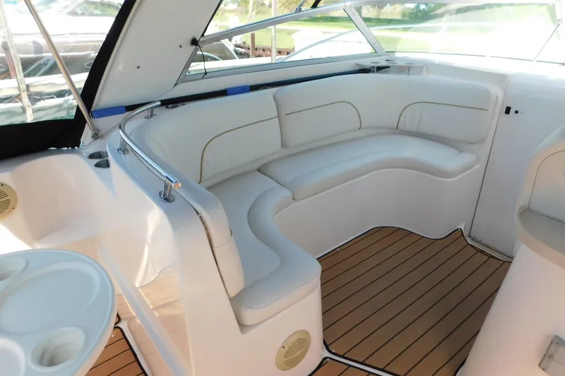 Slide: The Image of Interior of 2002 Rinker Fiesta Vee 310 boat with white seating and wood flooring. - 12