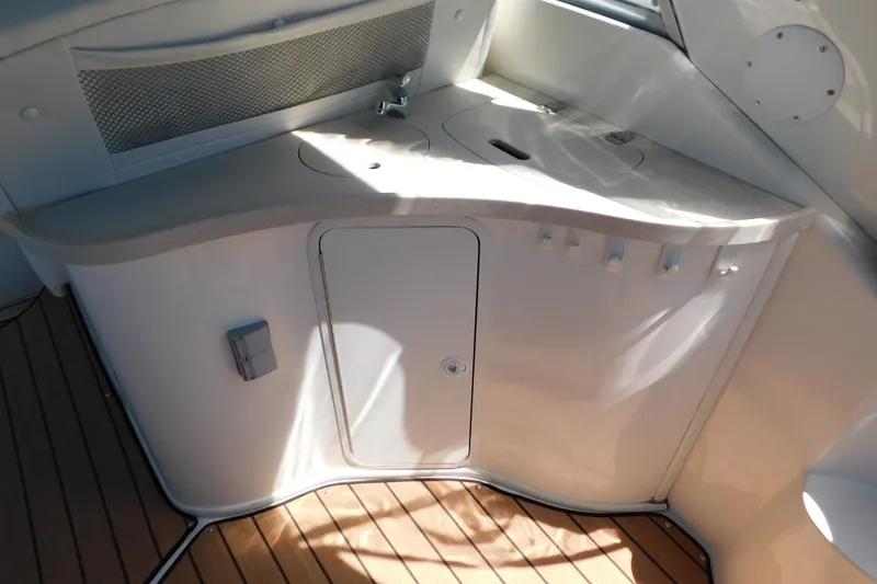 Slide: The Image of 2002 Rinker Fiesta Vee 310 boat interior with sink and storage cabinet. - 15