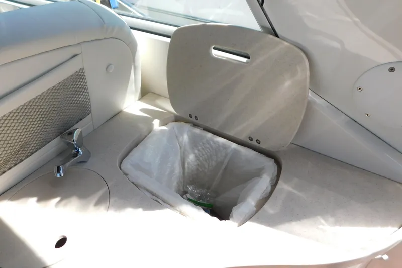 Slide: The Image of Interior of 2002 Rinker Fiesta Vee 310 boat with trash bin and faucet. - 16
