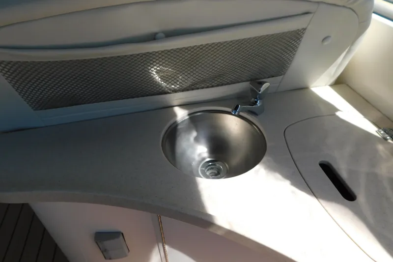 Slide: The Image of 2002 Rinker Fiesta Vee 310 boat interior with sink and countertop. - 17