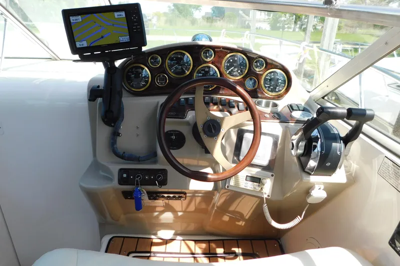 Slide: The Image of Cockpit of 2002 Rinker Fiesta Vee 310 with steering wheel and navigation system. - 19