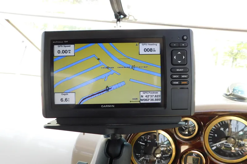 Slide: The Image of Garmin GPS display on 2002 Rinker Fiesta Vee 310 boat dashboard, showing navigation details. - 20