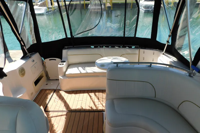 Slide: The Image of 2002 Rinker Fiesta Vee 310 boat interior with seating and wooden flooring. - 26