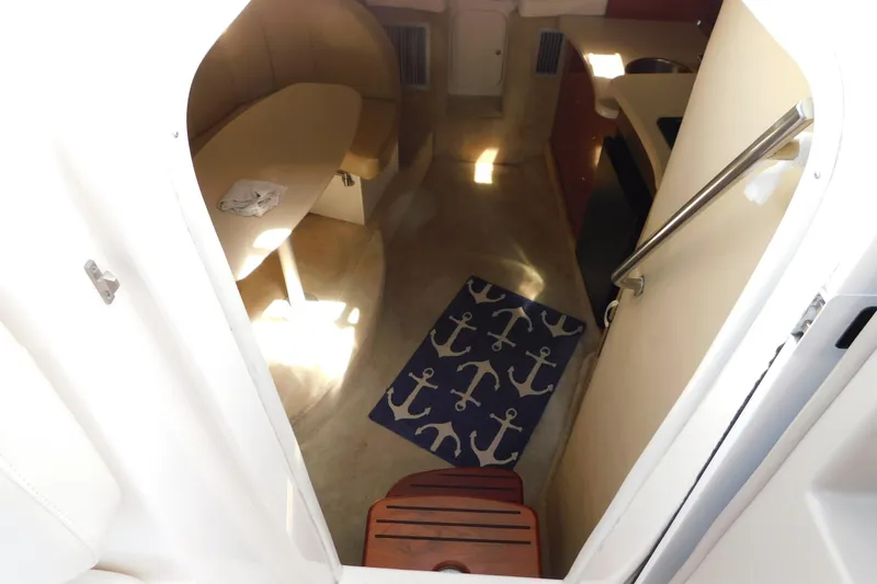 Slide: The Image of Interior view of 2002 Rinker Fiesta Vee 310 cabin with anchor-themed rug. - 30