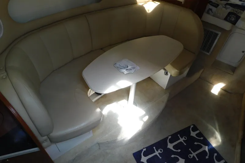 Slide: The Image of Interior of 2002 Rinker Fiesta Vee 310 with beige seating and table. - 31