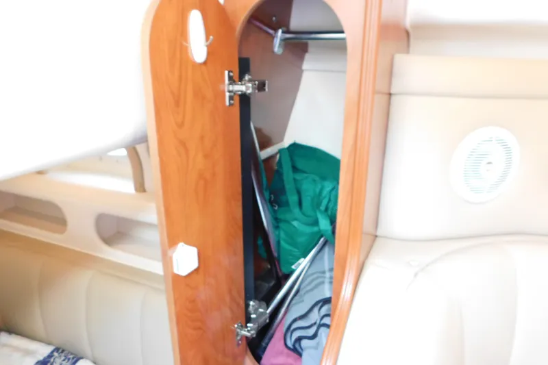 Slide: The Image of Interior cabin storage of 2002 Rinker Fiesta Vee 310 boat, featuring wooden cabinetry. - 37