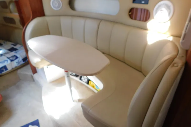 Slide: The Image of 2002 Rinker Fiesta Vee 310 interior with beige seating and oval table. - 38
