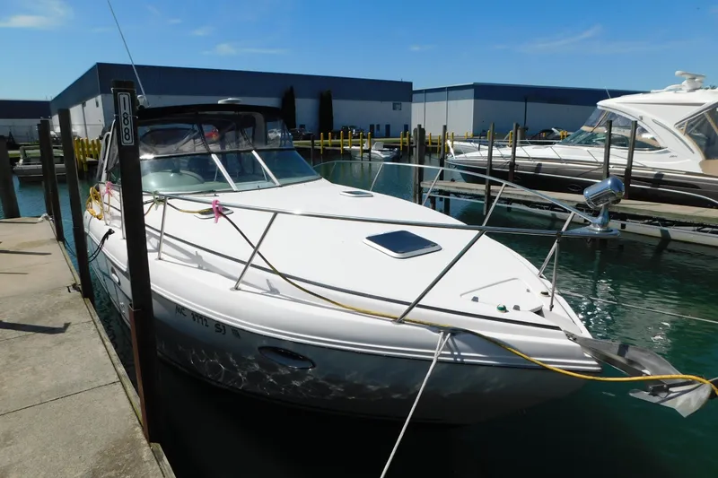 Slide: The Image of 2002 Rinker Fiesta Vee 310 docked at marina under clear blue sky. - 4