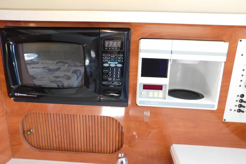 Slide: The Image of 2002 Rinker Fiesta Vee 310 galley with microwave and coffee maker. - 45