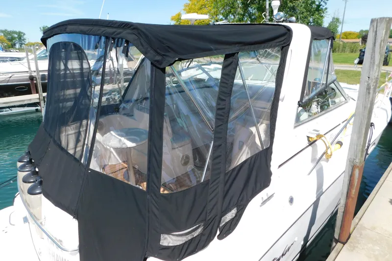 Slide: The Image of 2002 Rinker Fiesta Vee 310 boat docked with black canopy cover. - 5