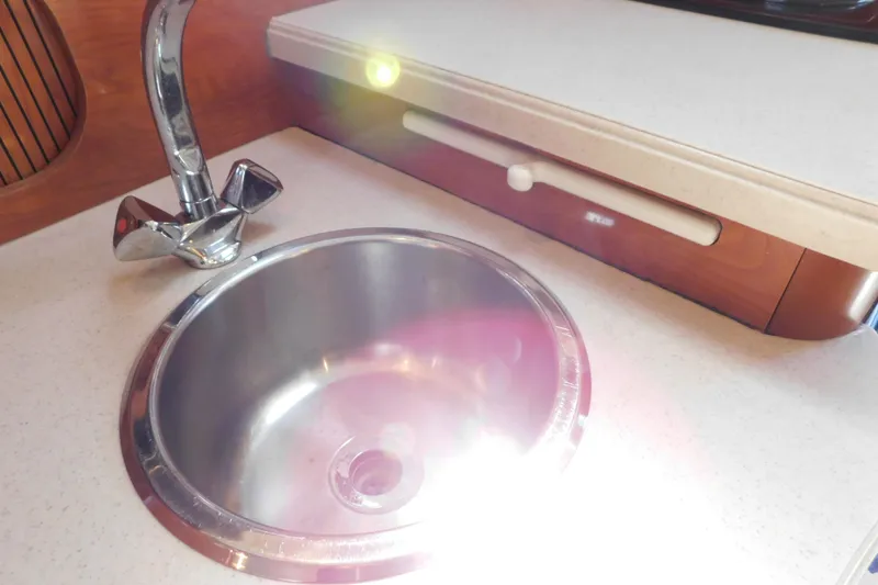 Slide: The Image of Stainless steel sink and faucet in 2002 Rinker Fiesta Vee 310 boat kitchen. - 51