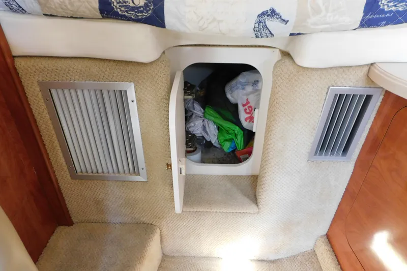 Slide: The Image of 2002 Rinker Fiesta Vee 310 cabin storage with open compartment and vents. - 58