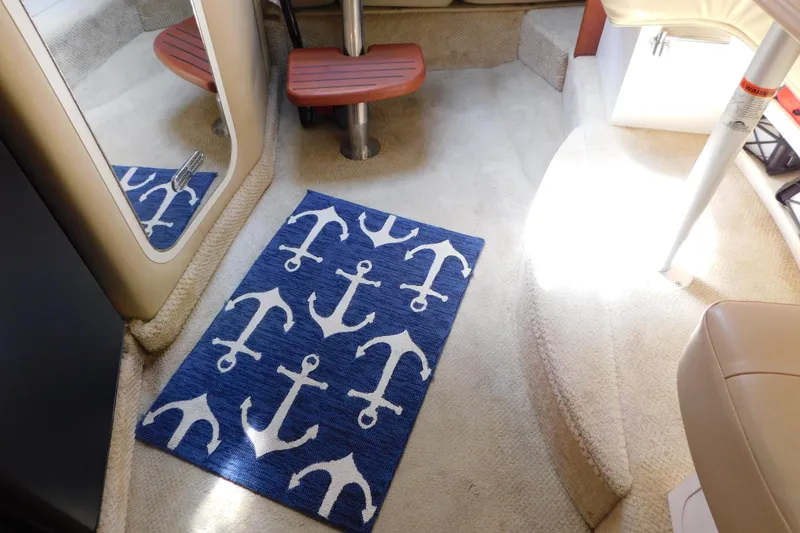 Slide: The Image of Interior of 2002 Rinker Fiesta Vee 310 with anchor-patterned rug on carpeted floor. - 59