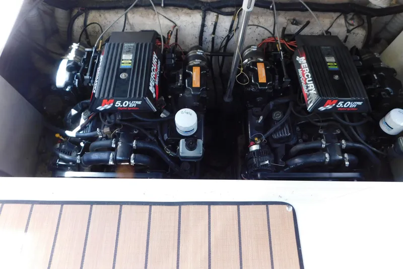 Slide: The Image of Twin Mercury 5.0L engines in a 2002 Rinker Fiesta Vee 310 boat. - 62