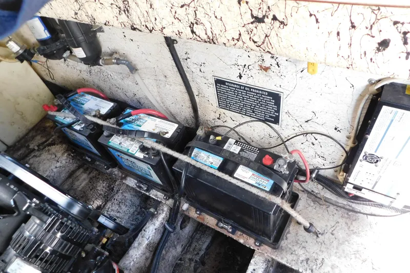 Slide: The Image of Engine compartment of 2002 Rinker Fiesta Vee 310 with multiple marine batteries. - 65