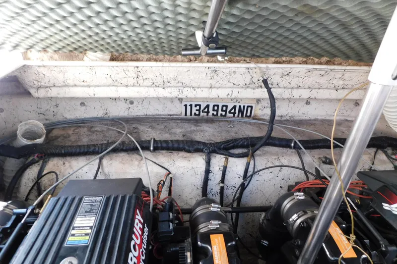 Slide: The Image of Engine compartment of a 2002 Rinker Fiesta Vee 310 boat with Mercury engines. - 68