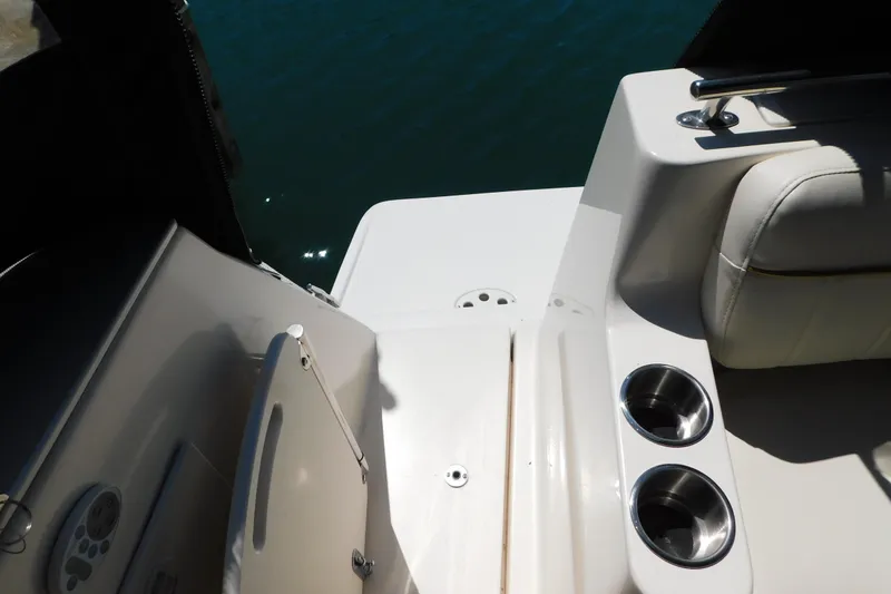 Slide: The Image of 2002 Rinker Fiesta Vee 310 boat interior with cup holders and seating area. - 70