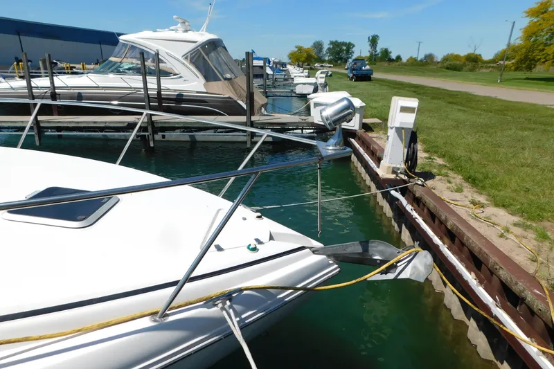 Slide: The Image of 2002 Rinker Fiesta Vee 310 docked at marina with clear blue sky. - 74