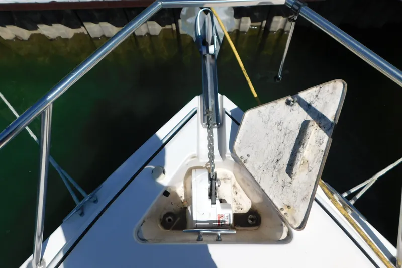 Slide: The Image of Bow of 2002 Rinker Fiesta Vee 310 with anchor chain and open hatch. - 76