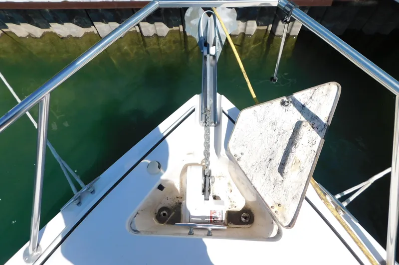 Slide: The Image of Bow of 2002 Rinker Fiesta Vee 310 with anchor chain and open hatch. - 77