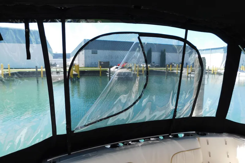 Slide: The Image of 2002 Rinker Fiesta Vee 310 boat interior with marina view through clear windows. - 9
