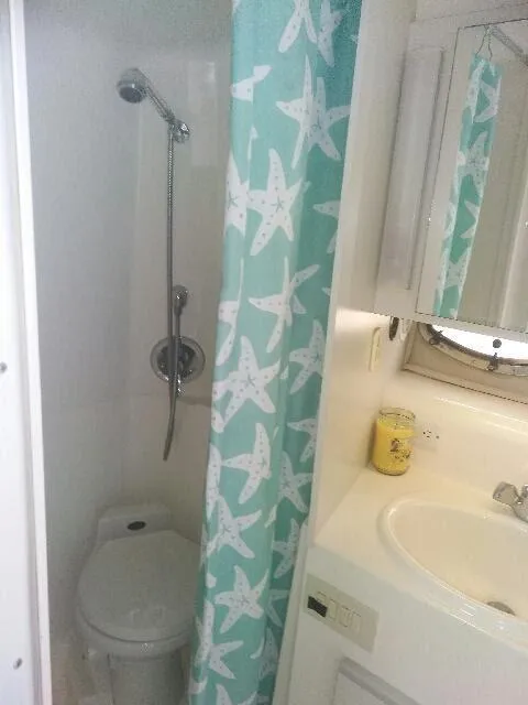 Slide: The Image of Interior of 1994 Cruisers Yachts 3672 Express with dining area and colorful decor. - 12